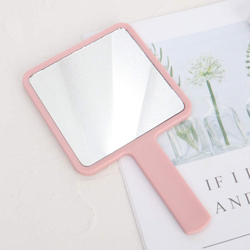 Hand held beauty mirror